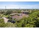 Aerial view of a multi-story condo building surrounded by lush landscaping and trees at 2650 Countryside Blvd # C204, Clearwater, FL 33761