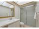 Clean bathroom with a modern vanity, a mirror and glass-enclosed shower at 2650 Countryside Blvd # C204, Clearwater, FL 33761