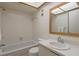 Bright bathroom with a tiled shower, vanity with a mirror, and a toilet at 2650 Countryside Blvd # C204, Clearwater, FL 33761