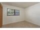 Cozy bedroom with neutral carpeting and a window offering natural light and outdoor views at 2650 Countryside Blvd # C204, Clearwater, FL 33761
