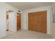 Bedroom featuring neutral walls, carpet flooring, a double closet, and access to a bathroom at 2650 Countryside Blvd # C204, Clearwater, FL 33761