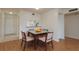 Cozy dining area featuring wood-look floors, a square dining table, and natural light at 2650 Countryside Blvd # C204, Clearwater, FL 33761