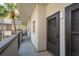 Condo entrance on a balcony walkway with view of palm trees at 2650 Countryside Blvd # C204, Clearwater, FL 33761