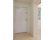 Interior entrance featuring a tile floor and a white door at 2650 Countryside Blvd # C204, Clearwater, FL 33761