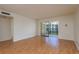 Spacious living room with hardwood floors and a sliding glass door to balcony at 2650 Countryside Blvd # C204, Clearwater, FL 33761