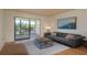 Comfortable living room with hardwood floors, neutral paint and a scenic view from the private balcony at 2650 Countryside Blvd # C204, Clearwater, FL 33761