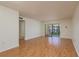 Living room with hardwood floors and sliding glass doors to balcony at 2650 Countryside Blvd # C204, Clearwater, FL 33761