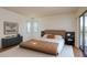 Well-lit main bedroom featuring a large window, a private balcony, and neutral decor at 2650 Countryside Blvd # C204, Clearwater, FL 33761
