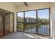 Screened-in patio overlooking a serene lake with a fountain and lush green landscaping at 2650 Countryside Blvd # C204, Clearwater, FL 33761