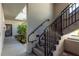 Exterior stairway with black metal railings leading to a landscaped entry area at 2650 Countryside Blvd # C204, Clearwater, FL 33761