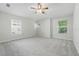 Spacious, carpeted bedroom with three windows providing ample natural light at 27563 Pleasure Ride Loop, Wesley Chapel, FL 33544
