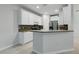 Modern kitchen with white cabinets, stone countertops, and stainless steel appliances at 27563 Pleasure Ride Loop, Wesley Chapel, FL 33544