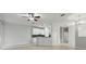 Open-concept living space with neutral walls, tile floors, and a kitchen area at 27563 Pleasure Ride Loop, Wesley Chapel, FL 33544