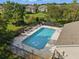 Inviting community pool, surrounded by lounge chairs and lush landscaping for relaxation and enjoyment at 27563 Pleasure Ride Loop, Wesley Chapel, FL 33544