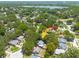 Aerial view of the property, showcasing its location amidst lush greenery and near a lake at 2770 Steeple Ct, Palm Harbor, FL 34684