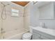 Cozy bathroom with tub and shower combo, light blue walls, and decorative wood ceiling at 2770 Steeple Ct, Palm Harbor, FL 34684