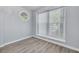 Serene bedroom with a large window offering natural light and modern flooring at 2770 Steeple Ct, Palm Harbor, FL 34684