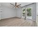 Bright bedroom featuring a ceiling fan, sliding glass doors, and neutral wall color at 2770 Steeple Ct, Palm Harbor, FL 34684