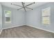 Bedroom with wood-look floors and large windows that bring in plenty of natural light at 2770 Steeple Ct, Palm Harbor, FL 34684