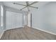 Bedroom features wood-look floors, fresh paint, large closet space, and modern ceiling fan at 2770 Steeple Ct, Palm Harbor, FL 34684