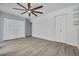 Spacious bedroom with white doors, a ceiling fan, and built-in shelving at 2770 Steeple Ct, Palm Harbor, FL 34684