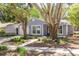 Charming single-story home with mature trees, blue accents, and well-maintained landscaping at 2770 Steeple Ct, Palm Harbor, FL 34684