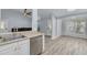 Open-concept kitchen with stainless steel dishwasher and view into the adjacent dining area at 2770 Steeple Ct, Palm Harbor, FL 34684