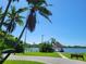 Scenic view of the lake with a charming gazebo, mature trees, and a tranquil atmosphere at 2770 Steeple Ct, Palm Harbor, FL 34684