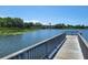 Picturesque lake view from a wooden dock, showcasing serene water and lush greenery in the background at 2770 Steeple Ct, Palm Harbor, FL 34684