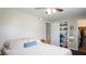 Bright bedroom with a closet featuring shelves and a door; ceiling fan present at 2941 Lichen Ln # B, Clearwater, FL 33760