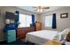 Bedroom with two windows and furniture, including a turquoise minibar next to a wooden dresser at 2941 Lichen Ln # B, Clearwater, FL 33760