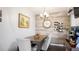 Charming dining area with rustic wood accent wall, wine rack, and elegant chandelier at 2941 Lichen Ln # B, Clearwater, FL 33760