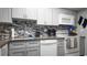 Renovated kitchen boasts granite counters, updated appliances, stylish backsplash, and ample cabinet space at 2941 Lichen Ln # B, Clearwater, FL 33760