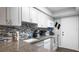 Well-lit kitchen with granite countertops, stainless steel appliances, ample counter space, and sleek cabinetry at 2941 Lichen Ln # B, Clearwater, FL 33760