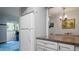 Cozy kitchen with granite countertops, access to an adjacent living area with natural light, and stainless steel appliances at 2941 Lichen Ln # B, Clearwater, FL 33760