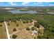Overhead view of a countryside property with a large lake in the background at 31949 Amberlea Rd, Dade City, FL 33523