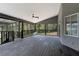Spacious back porch with railings, a ceiling fan, and views of the serene outdoor landscape at 31949 Amberlea Rd, Dade City, FL 33523