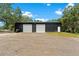 Large barn with two roll-up doors, providing ample space for storage and workshop activities at 31949 Amberlea Rd, Dade City, FL 33523