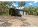 Side view of a large barn with roll-up doors, offering practical space for a workshop, storage, or more at 31949 Amberlea Rd, Dade City, FL 33523