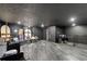 Large basement with modern gray floors and black walls, ready for personalization and diverse applications at 31949 Amberlea Rd, Dade City, FL 33523