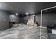 Finished basement with gray toned floor and overhead lighting at 31949 Amberlea Rd, Dade City, FL 33523