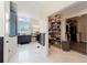 Modern bathroom with dual vanities, a glass shower, marble floors, and a custom shoe closet at 31949 Amberlea Rd, Dade City, FL 33523