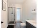 Modern bathroom boasts a glass shower, sleek fixtures, and a gray wood-look tile floor at 31949 Amberlea Rd, Dade City, FL 33523