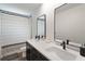 Bathroom featuring double sink vanity, shower, and elegant mirrors at 31949 Amberlea Rd, Dade City, FL 33523