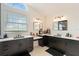 Bright bathroom featuring dual sinks, black cabinets, white countertop and light fixtures at 31949 Amberlea Rd, Dade City, FL 33523