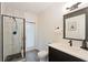 Stylish bathroom featuring a glass shower, modern vanity, and sleek black fixtures at 31949 Amberlea Rd, Dade City, FL 33523
