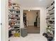 Bright closet features shoe rack storage on white shelving leading to dressing room at 31949 Amberlea Rd, Dade City, FL 33523