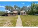 Charming single-story home with a brick facade and a well-manicured front yard at 31949 Amberlea Rd, Dade City, FL 33523