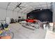 Wide angle view of the storage garage with lighting, a car, kayaks, tools and other various objects at 31949 Amberlea Rd, Dade City, FL 33523