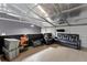 The metallic interior has a wooden floor with storage containers, a flat-screen TV, and a black leather sofa at 31949 Amberlea Rd, Dade City, FL 33523